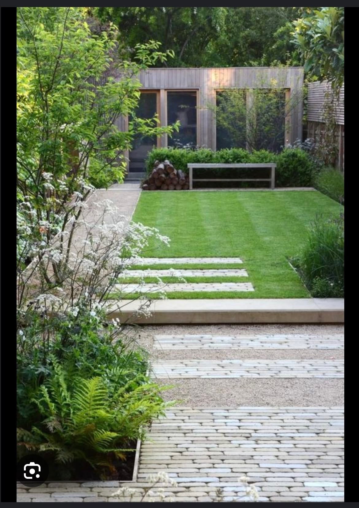 Lawn with a stepping-stone path beside a patio