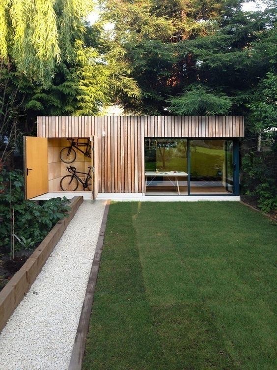 Timber-clad garden room with bike storage