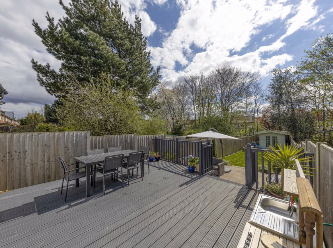 Existing deck dining table with the summer house beyond