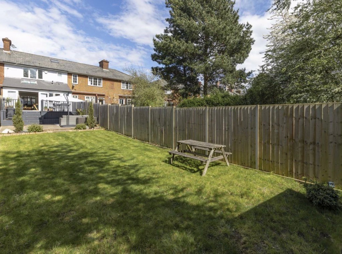 Existing lawn with picnic bench along the fence line