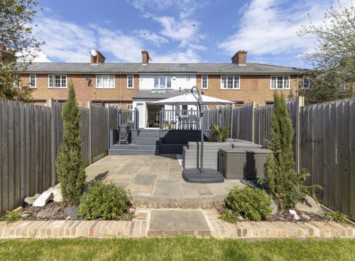 Existing patio and deck with the house behind